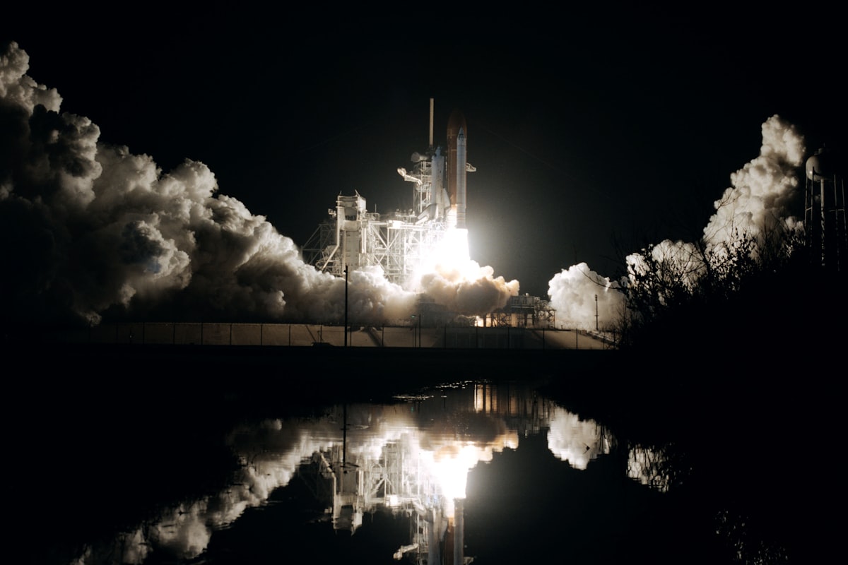 Space shuttle taking off against a dark sky